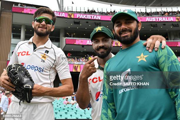 Pakistan's Shaheen Afridi , Sajid Khan and bowling coach Saeed Ajmal poses for pictures during the second day of the third cricket Test match between...