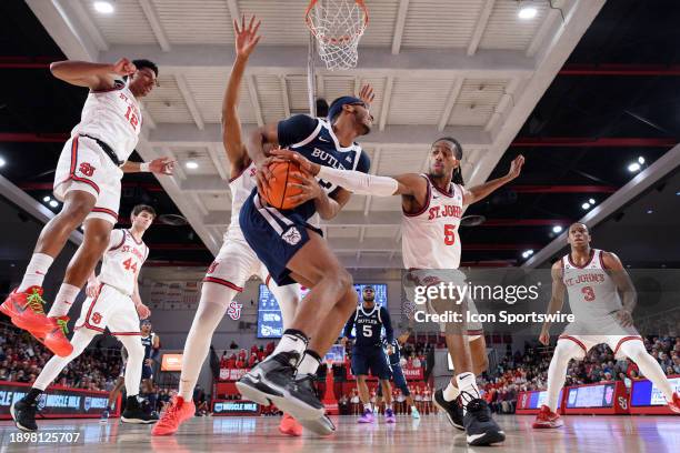 St John's Red Storm guard Daniss Jenkins reaches in for a steal against Butler Bulldogs center Andre Screen during the men's college basketball game...