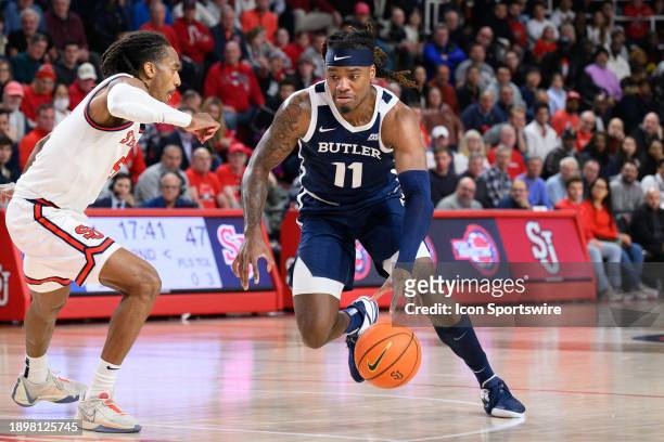 Butler Bulldogs forward Jahmyl Telfort drives into the lane against St John's Red Storm guard Daniss Jenkins during the men's college basketball game...