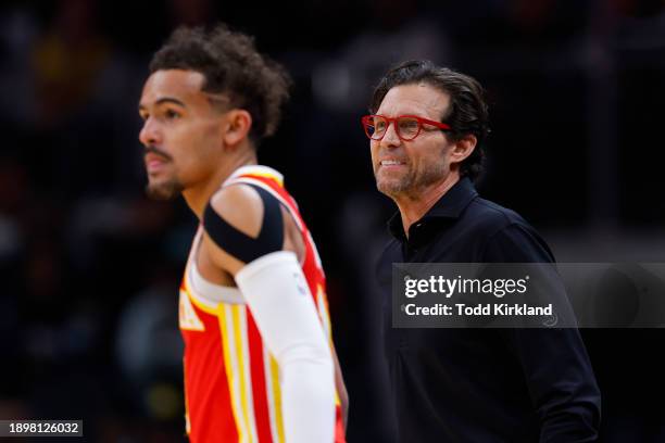 Head coach Quin Snyder of the Atlanta Hawks looks on with Trae Young during the first quarter against the Oklahoma City Thunder at State Farm Arena...