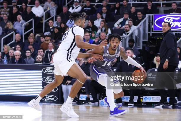 Seton Hall Pirates guard Dre Davis drives to the basket against Providence Friars forward Bryce Hopkins during the college basketball game between...