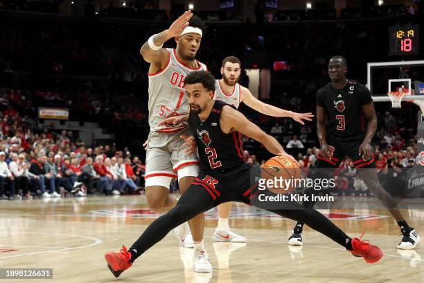 Noah Fernandes of the Rutgers Scarlet Knights drives the ball against the defense of Roddy Gayle Jr. #1 of the Ohio State Buckeyes during the second...