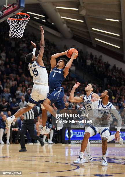 Desmond Claude of the Xavier Musketeers shoots the ball against Jordan Longino of the Villanova Wildcats in the first half at Finneran Pavilion on...