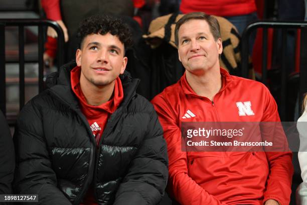 Athletic Director Trev Alberts of the Nebraska Cornhuskers sits with football recruit Dylan Raiola before the game against the Indiana Hoosiers at...