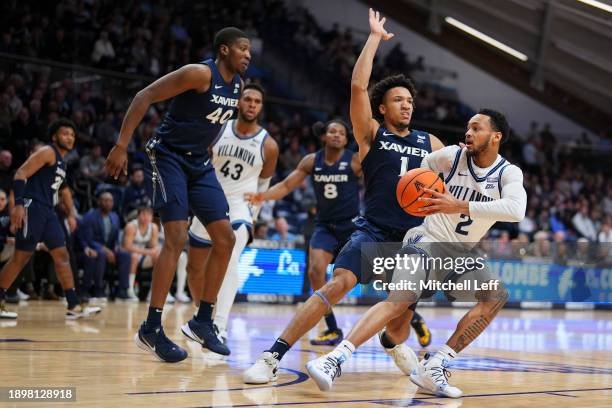 Mark Armstrong of the Villanova Wildcats controls the ball against Desmond Claude of the Xavier Musketeers in the second half at Finneran Pavilion on...
