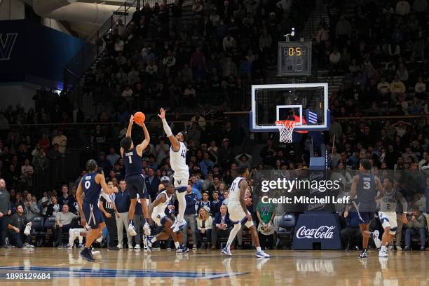 Desmond Claude of the Xavier Musketeers misses a shot against Eric Dixon of the Villanova Wildcats in the final seconds of the second half at...