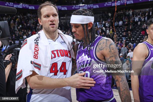 Bojan Bogdanovic of the Detroit Pistons hugs Jordan Clarkson of the Utah Jazz after the game on January 1, 2024 at vivint.SmartHome Arena in Salt...