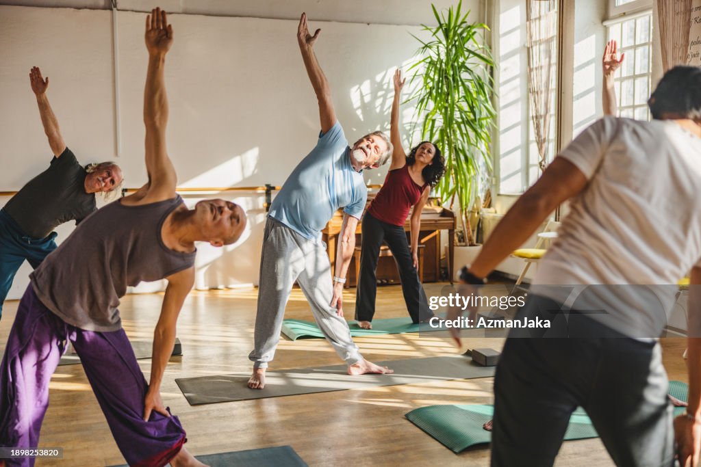 Group Of Multicultural Yoga Students Observing And Practicing During Class