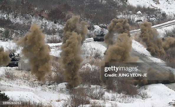 A South Korean K1A2 tank fires smoke shells during a joint live fire ...