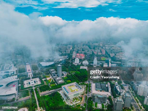aerial view of urban buildings in the fog - in air location stock pictures, royalty-free photos & images