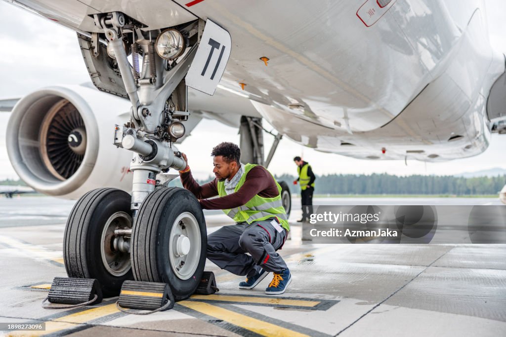 Aircraft Mechanic Maintaining Jet Airplane