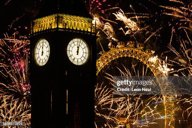Queen Elizabeth Tower, commonly known as Big Ben, is seen as as fireworks erupt from the London Eye on January 01, 2024 in London, England. Each year...