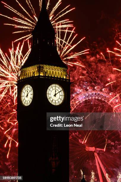 Queen Elizabeth Tower, commonly known as Big Ben, is seen as as fireworks erupt from the London Eye on January 01, 2024 in London, England. Each year...