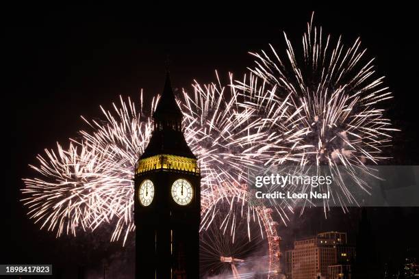 Queen Elizabeth Tower, commonly known as Big Ben, is seen as as fireworks erupt from the London Eye on January 01, 2024 in London, England. Each year...