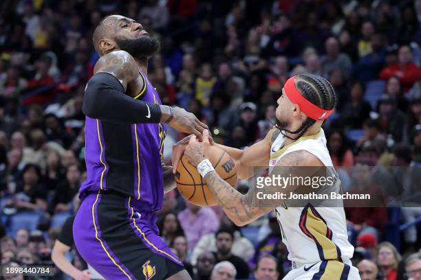 Jose Alvarado of the New Orleans Pelicans steals the ball from LeBron James of the Los Angeles Lakers during the first half at the Smoothie King...