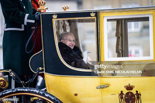 Queen Margrethe II of Denmark waves as she is escorted by the Gardehusar Regiment's Horseskort in the gold carriage from Christian IX's Palace,...