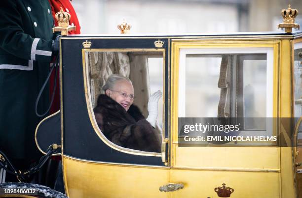 Queen Margrethe II of Denmark waves as she is escorted by the Gardehusar Regiment's Horseskort in the gold carriage from Christian IX's Palace,...