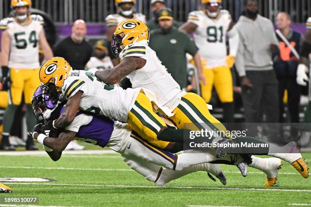 Jordan Addison of the Minnesota Vikings is tackled by Corey Ballentine of the Green Bay Packers after a catch during the second quarter at U.S. Bank...