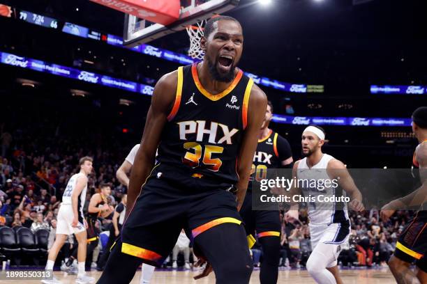 Kevin Durant of the Phoenix Suns reacts after dunking during the second half against the Orlando Magic at Footprint Center on December 31, 2023 in...