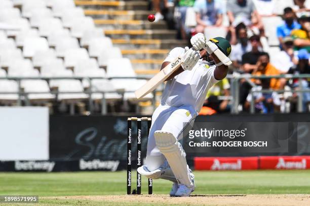 South Africa's Lungi Ngidi reacts after being hit by a ball delivered by India's Prasidh Krishna during the second day of the second cricket Test...