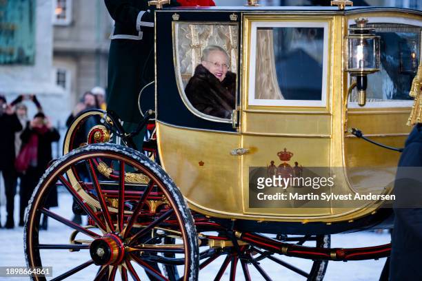 Queen Margrethe II of Denmark sits in the Golden Carriage escorted by the Guard Hussar Regiment's Mounted Squadron from Amalienborg to Christiansborg...