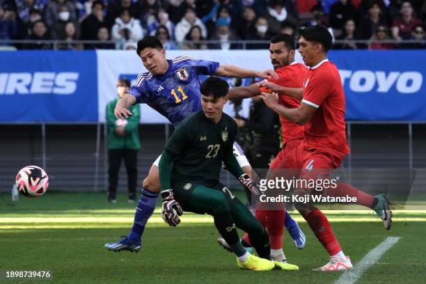 Mao Hosoya of Japan competes for the ball against Thailand defense during the international friendly match between Japan and Thailand at National...