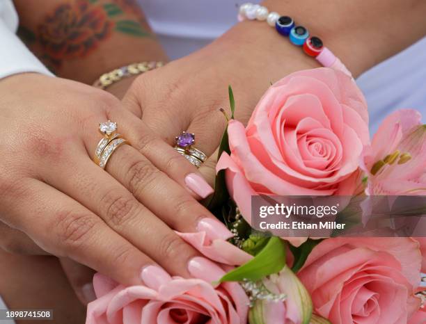 Annamarie Popoca and Michelle Antonio display their rings after their wedding ceremony at the Viva Las Vegas Wedding Chapel on December 31, 2023 in...