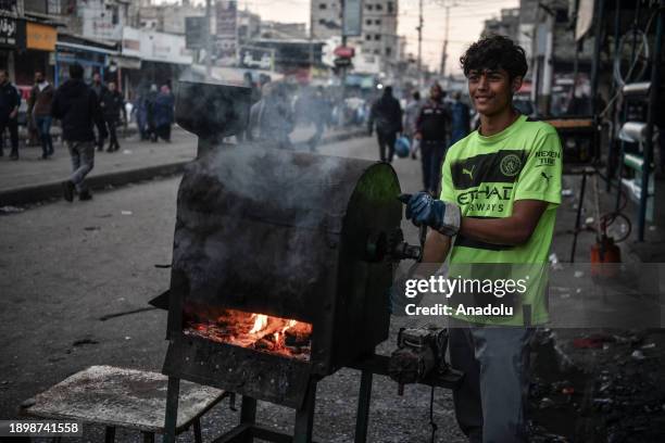 Street vendor Palestinian boy wait for customer on the street while Israel's attacks continue on Gaza Strip as Palestinians who took refuge in the...