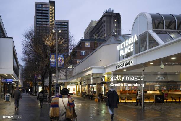 Shops line Commercial Way, a pedestrianized retail street, in Woking, UK, on Tuesday, Dec. 19, 2023. Woking became the first of three councils last...