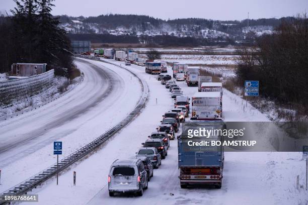 Number of trucks and cars are stuck on the E45 motorway near Randers in Jutland, Denmark, on January 4 after a heavy snowstorm has disturbed traffic...