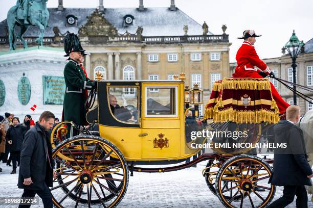 Queen Margrethe II of Denmark waves from the golden carriage as she is escorted by the Gardehusar Regiment's Horseskort from Christian IX's Palace,...