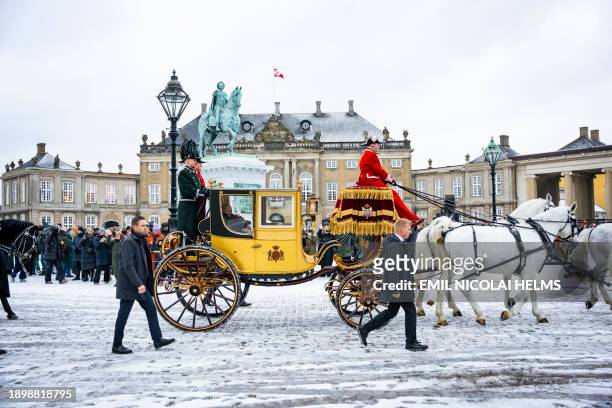 Queen Margrethe II of Denmark waves from the golden carriage as she is escorted by the Gardehusar Regiment's Horseskort from Christian IX's Palace,...