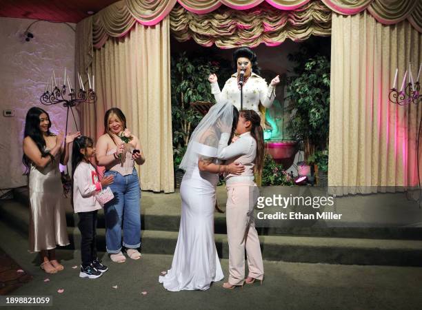 Monica Harmon, Melissa Antonio and Cecilia Antonio look on as Mark Felton Jr., as drag queen Elvis Presley Martina "Sh-Elvis" Brookshire, officiates...