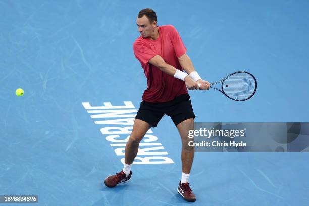 Roman Safiullin plays a backhand in his match agianst Ben Shelton of USA during day two of the 2024 Brisbane International at Queensland Tennis...