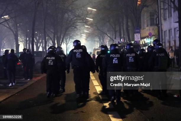 Police officers keep watch over a situation at Sonnenallee Street in the Neukoelln district on January 01, 2024 in Berlin, Germany. Police in Berlin...