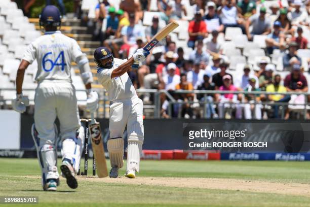India's Rohit Sharma hits a four during the second day of the second cricket Test match between South Africa and India at Newlands stadium in Cape...