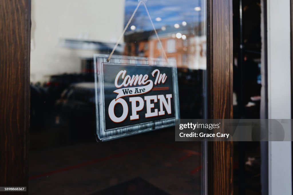Open Sign Hangs From Store's Front Door