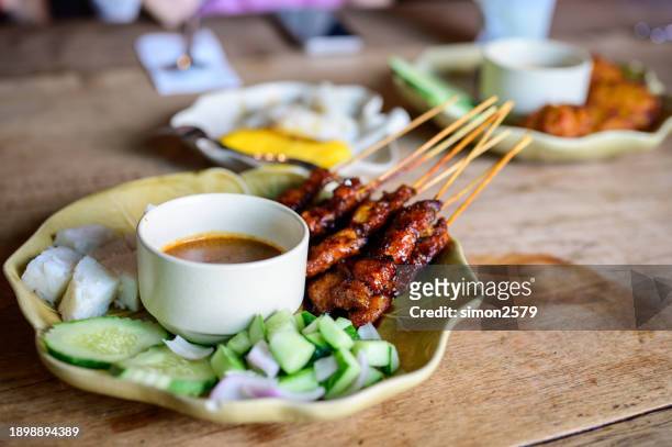 chicken satay with peanut sauce - traditional malay food stock pictures, royalty-free photos & images