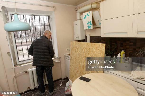 Man is installing new windows in the kitchen of an apartment on Alana Sheparda Street in Dnipro, Central Ukraine, on January 3, 2024. The windows...