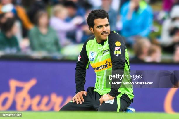 Oliver Davies of the Thunder reacts after fielding a ball during the BBL match between Hobart Hurricanes and Sydney Thunder at Blundstone Arena, on...