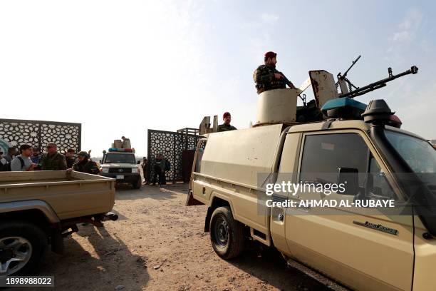 Members of Iraq's Hashed al-Shaabi stand guard at the entrance of their headquarters in Baghdad on January 4 following a reported strike on January...
