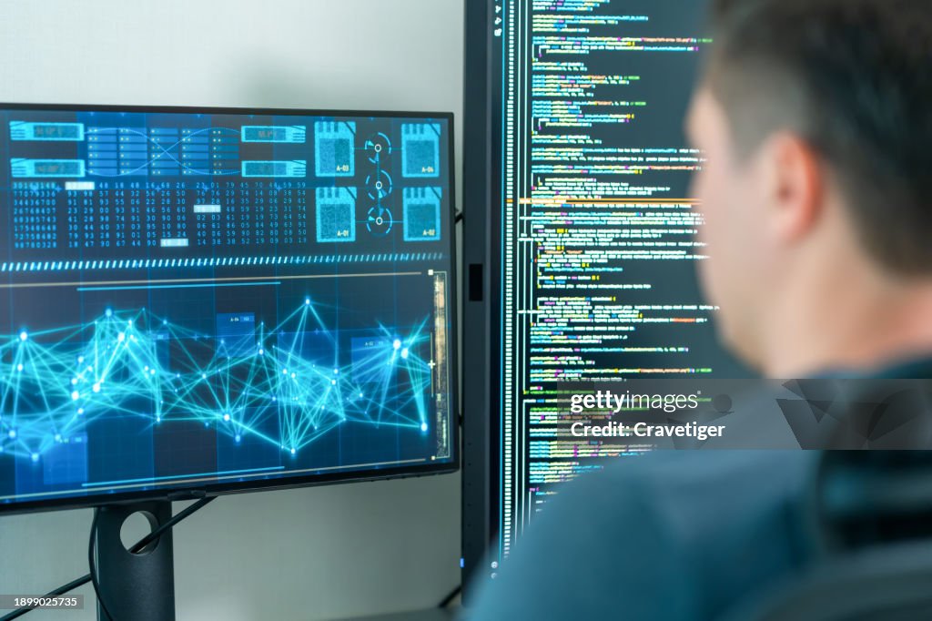 Software developers using computer to write code sitting at desk with multiple screens work remotely in home . Programmer development concept.