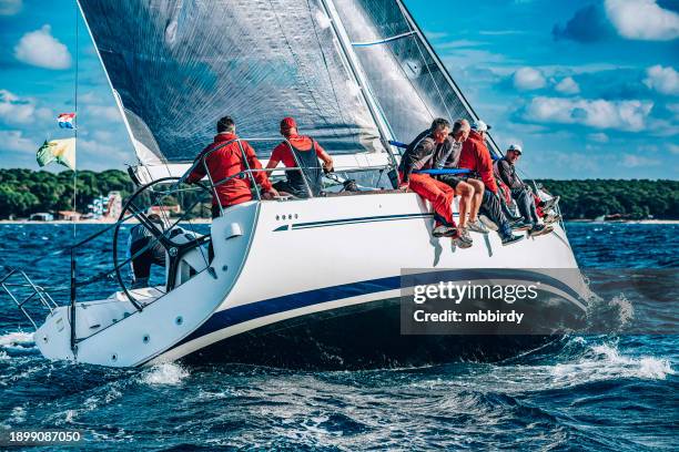 sailing crew on sailboat on regatta - rudder stock pictures, royalty-free photos & images
