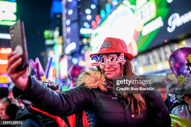 Woman takes a selfie during the Times Square New Year's Eve 2024 Celebration on December 31, 2023 in New York City.