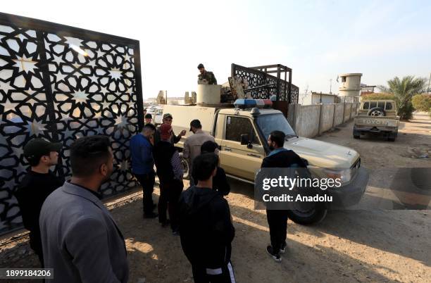 Iraqi security forces arrive to inspect the site where Al-Nujaba senior commander Abu Taqwa Al-Saidi was killed in a US drone strike, at logistical...