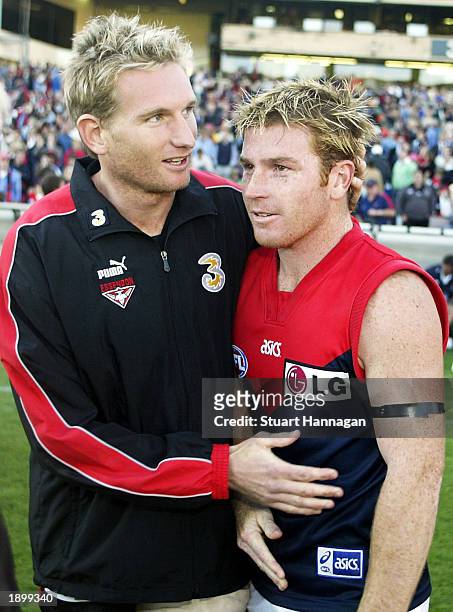 James Hird of Essendon meets with ex team mate Gary Moorcroft after the AFL Round two match between the Essendon Bombers and the Melbourne Demons at...