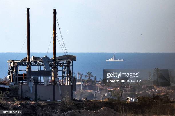 An Israeli navy warship sails in the Mediterranean sea waters off the coast of the Gaza Strip as pictured from a position along the border in...