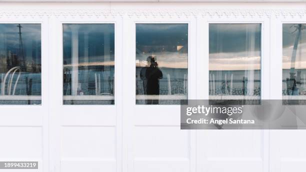 reflection of photographer in window panes - moment of silence stock pictures, royalty-free photos & images