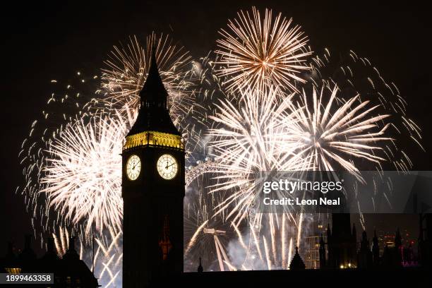 Queen Elizabeth Tower, commonly known as Big Ben, is seen as as fireworks erupt from the London Eye on January 01, 2024 in London, England. Each year...