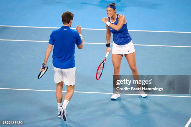 Caroline Garcia of France and Edouard Roger-Vasselin of France celebrate winning a point in the Group D doubles match against Alexander Zverev of...